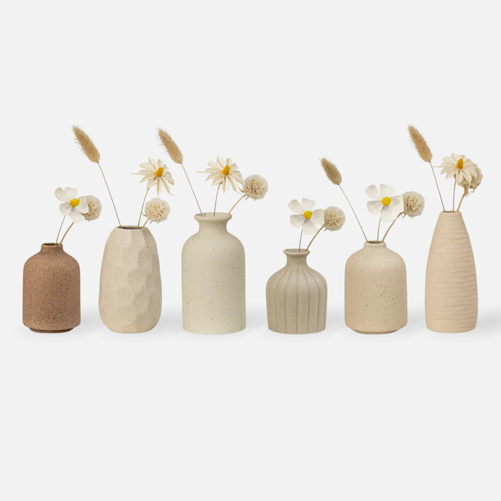 Terra Lume ceramic and porcelain vases with natural clay pottery texture and dark spots, holding fresh and dried flowers in various sizes
