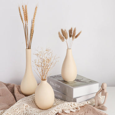 Kaya ceramic and porcelain vase set of three with teardrop, bulb, and long-neck bottle shapes, holding fresh and dried flowers